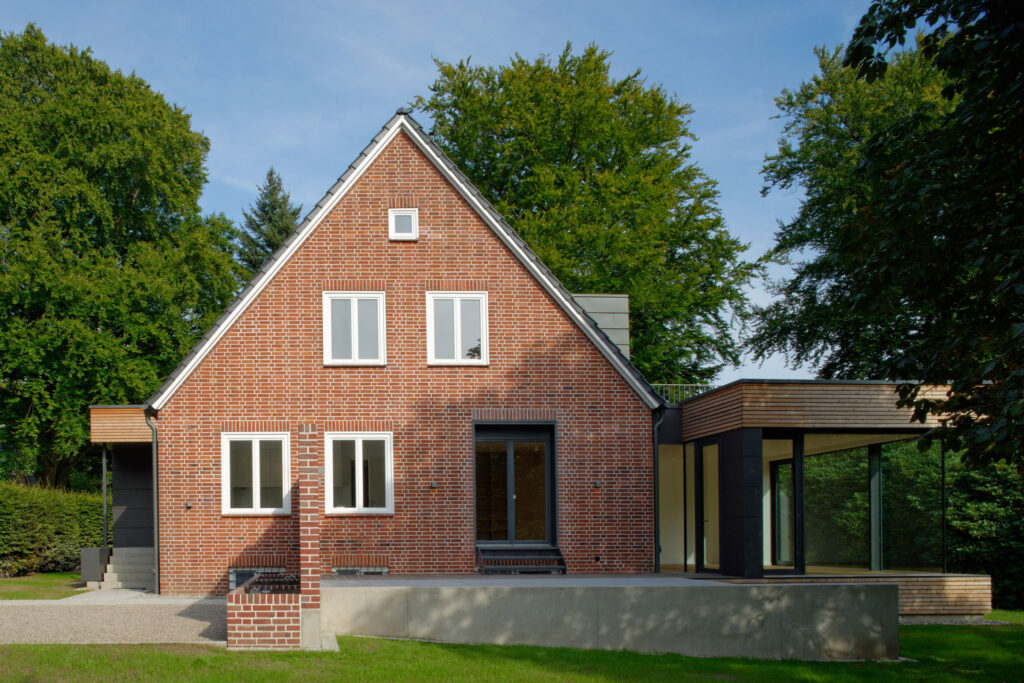 Blick auf flachen Anbau an einem Einfamilienhaus aus Backstein
